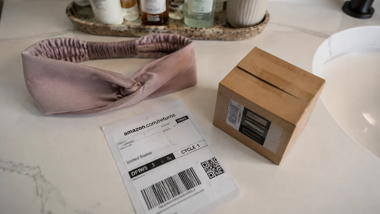Headband laid flat on a bathroom counter next to a small return shipping label and box, suggesting the exchange process